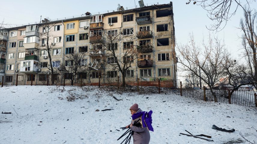 A woman, who is a school employee, walks near the site of an apartment building hit by a Russian drone strike, amid Russia's attack on Ukraine, in Kyiv, Ukraine February 3, 2026.