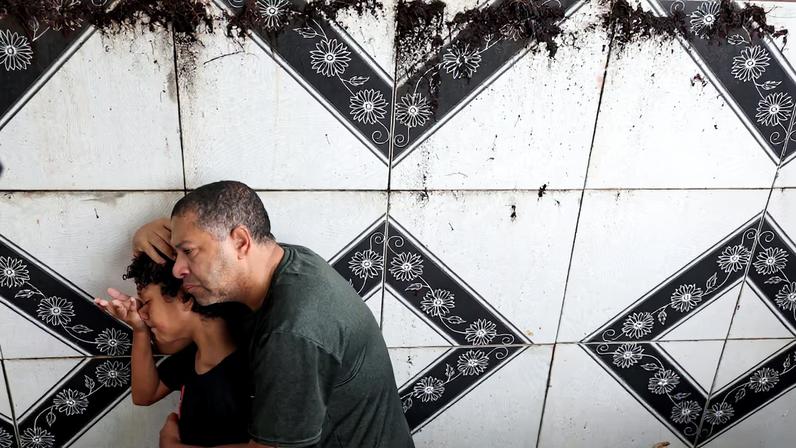 People attend the funeral of 11-year-old Bernardo Lopes Dutra, one of the victims of heavy rains in Juiz de Fora