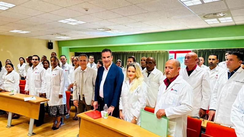 Governor of Italy's Calabria region Roberto Occhiuto poses with Cuban medics whom he has hired to help deal with a shortage of staff in local hospitals, at the University of Calabria in Cosenza, Italy, in this undated picture obtained by Reuters on October 3, 2023.