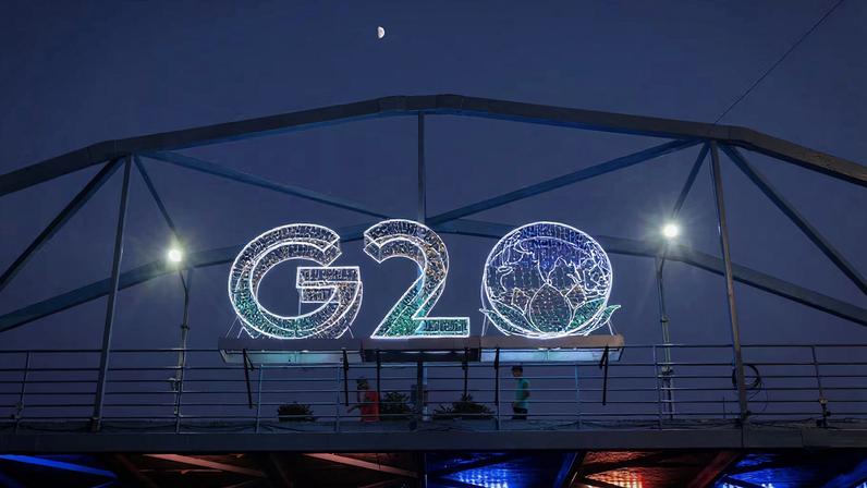 Moon is pictured above a G20 logo installed on a pedestrian bridge in front of the main venue of the summit in New Delhi