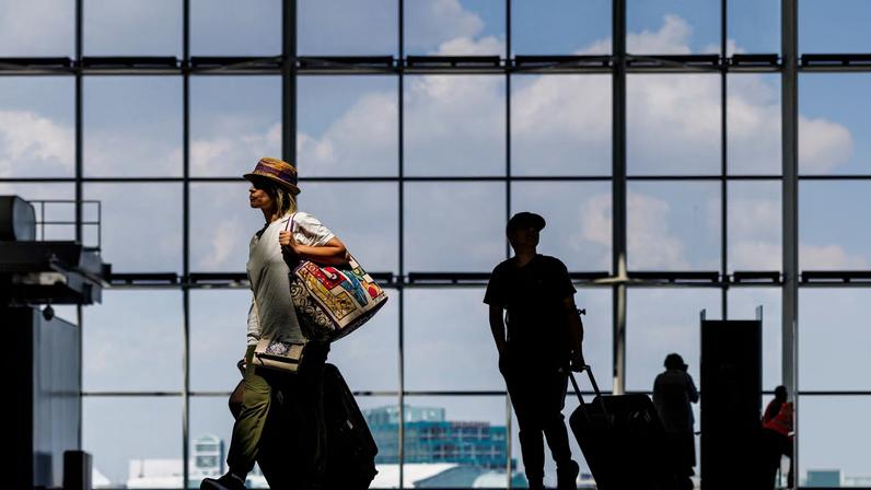People arrive with their luggage at Toronto Pearson International Airport in Mississauga, Ontario, Canada August 11, 2025. REUTERS/Carlos Osorio