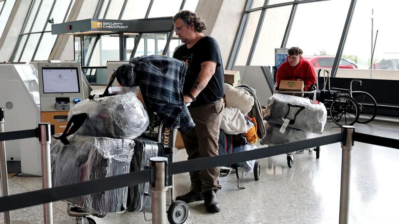 People from the first group of white South Africans granted refugee status for being deemed victims of racial discrimination under U.S. President Trump's Refugee plan, check in for a connecting flight, at Dulles International Airport, in Dulles, Virginia, U.S., May 12, 2025. REUTERS/Jonathan Ernst