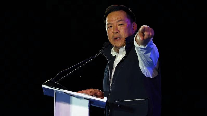 Thailand's caretaker Prime Minister Anutin Charnvirakul, Bhumjaithai Party leader and prime ministerial candidate, gestures during a general election campaign rally ahead of the February 8 election in Bangkok