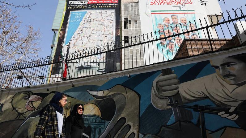 Iranian women walk past an anti-Israeli billboard in Tehran, Iran, February 19, 2026. Majid Asgaripour/WANA (West Asia News Agency) via REUTERS
