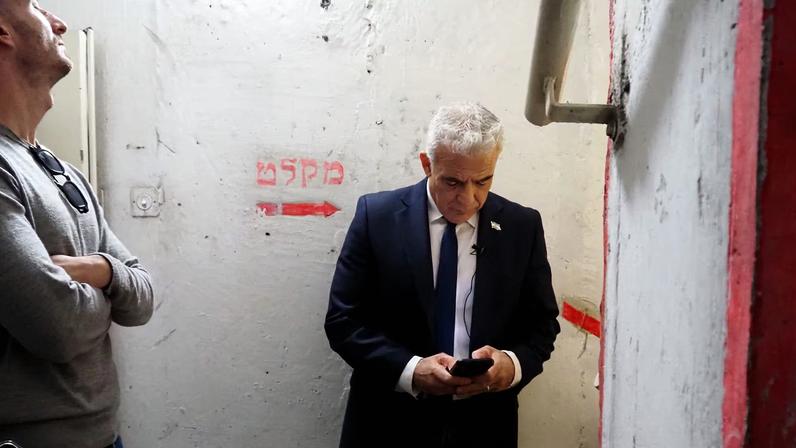 Israeli opposition leader Yair Lapid uses his phone in a shelter as sirens sound after missiles were launched towards Israel from Iran following strikes by Israel and the U.S. on Iran, in Tel Aviv, Israel February 28, 2026. REUTERS/Alexander Cornwell