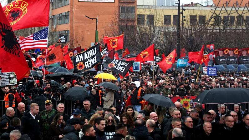 Demonstrators wave flags at a protest in support of former Kosovo President Hashim Thaci and other former Kosovo Liberation Army (KLA) members, who are on trial for war crimes at a court in the Netherlands as Kosovars celebrate the 18th anniversary of independence, in Pristina, Kosovo, February 17, 2026. REUTERS/Florion Goga