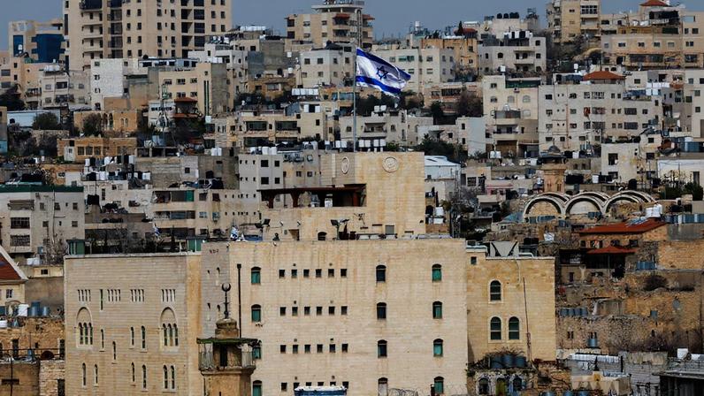 An Israeli flag flies over an Israeli settlement in the old city in Hebron in the Israeli-occupied West Bank, February 9, 2026. REUTERS/Mussa Qawasma