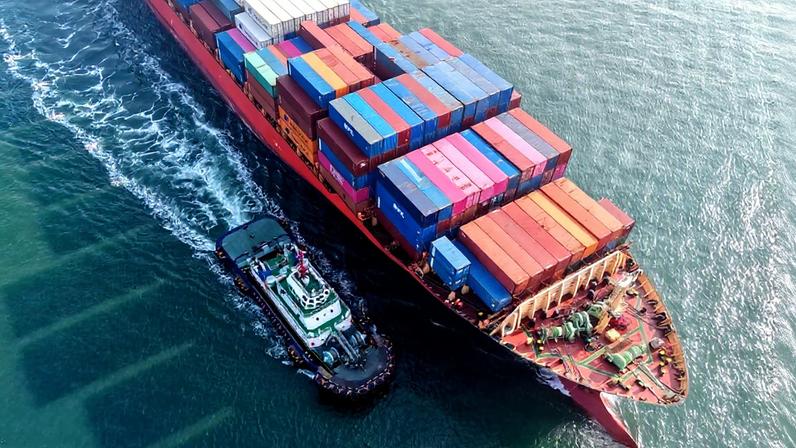 A container ship is guided into the port in Qingdao, China, on Feb. 4.