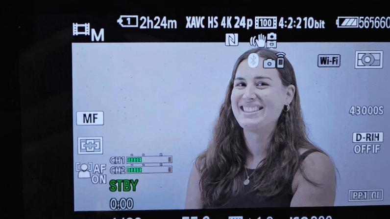 Lucía Torres posing while the crew frames the side camera for Mongabay’s Against All Odds video series in 2024. Image by Samantha Lee/Mongabay.