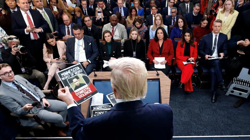 U.S. President Donald Trump holds images of alleged criminals taken off the street by ICE as he speaks during a press briefing at the White House, on the one-year mark into his second term in office, in Washington, D.C., U.S., January 20, 2026. REUTERS/Jessica Koscielniak