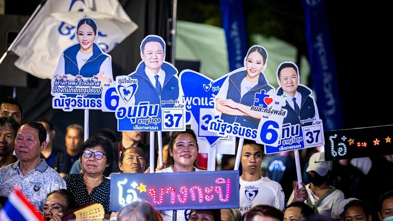 Bhumjaithai Party supporters hold cutouts of Prime Minister Anutin Charnvirakul during a rally in Bangkok on Jan. 30.