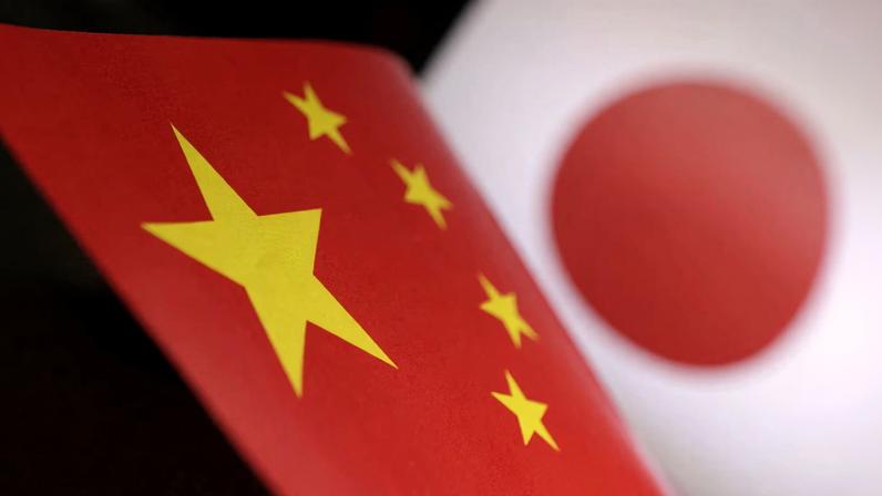 Printed Chinese and Japanese flags are seen in this illustration, July 21, 2022. REUTERS/Dado Ruvic/Illustration