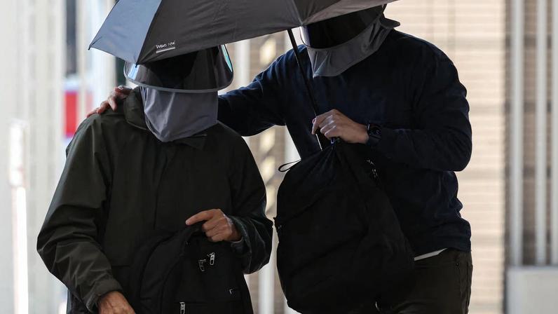 Kwok Yin-sang, father of wanted U.S.-based activist Anna Kwok, arrives at the West Kowloon Magistrates’ Courts building in Hong Kong