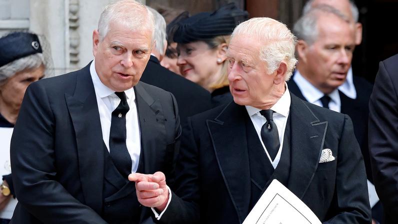 Prince Andrew and King Charles III conversing.