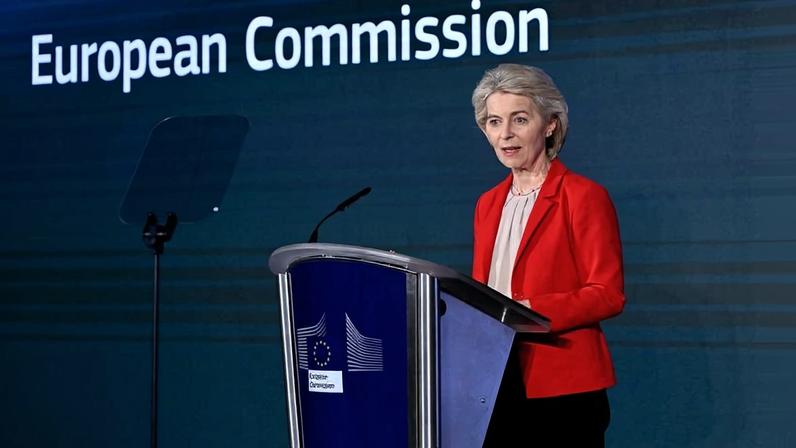European Commission President Ursula von der Leyen speaks at a podium at the European Union headquarters in Brussels.