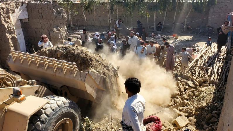 Residents gather as machinery clears the debris of a damaged house, following the Pakistani air strikes, in Nangarhar, Afghanistan, February 22, 2026. REUTERS/Stringer/File Photo