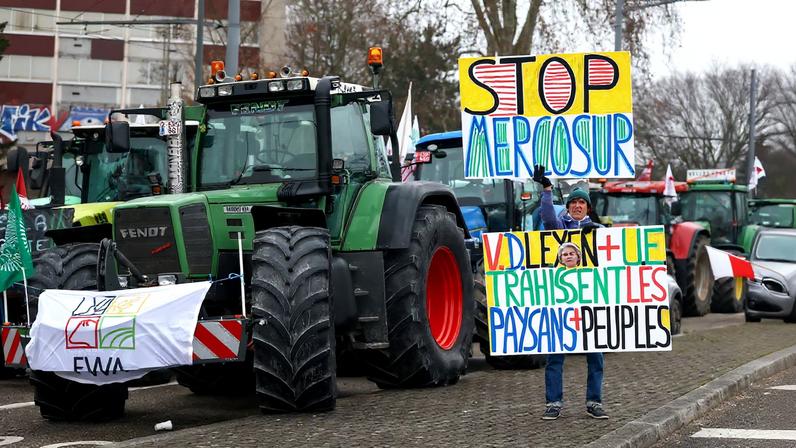 A man holds placards, as French farmers from FNSEA and Jeunes Agriculteurs farm unions take part in a demonstration to protest against the EU-Mercosur free trade agreement, in Strasbourg, France, January 20, 2026.