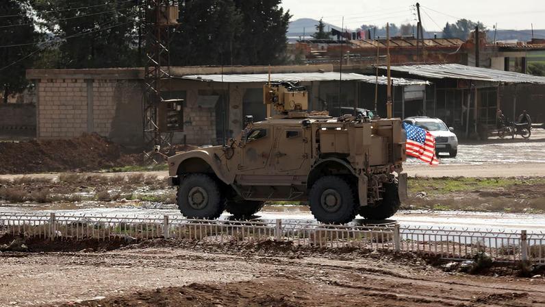 A U.S. military vehicle moves during the transportation of Islamic State detainees from Syria to Iraq, according to a security source from the Syrian Democratic Forces, in Qamishli, Syria, February 8, 2026.