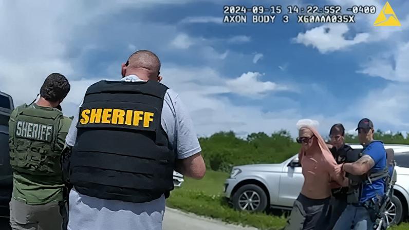 Ryan W. Routh, suspected of attempting to assassinate Republican presidential nominee and former U.S. President Donald Trump at his West Palm Beach golf course, is held by two Martin County Sheriff's Office deputies after his arrest during a traffic stop near Palm City.