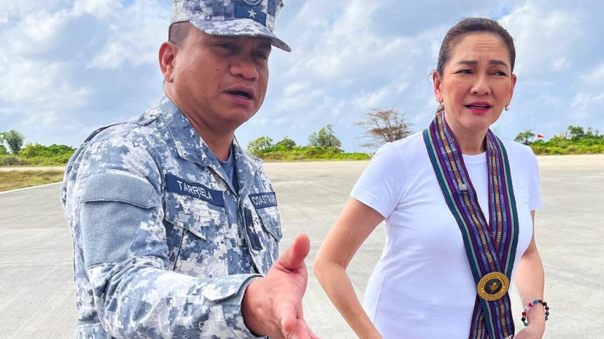 Philippine Coast Guard spokesperson Commodore Jay Tarriela gestures beside Philippine Senator Risa Hontiveros during a visit to Philippine-occupied Thitu Island in the disputed South China Sea