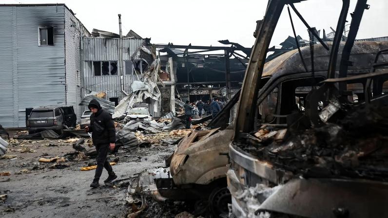 A man walks near damaged cars at the site of a Russian drone strike, amid Russia's attack on Ukraine, in Odesa, Ukraine February 13, 2026. REUTERS/Nina Liashonok