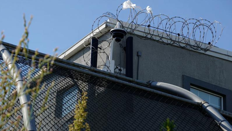A surveillance camera sits outside of Delaney Hall, a 1,000-person detention center operated by private prison company GEO Group for Immigration and Customs Enforcement (ICE), in the Ironbound neighborhood of Newark, New Jersey, U.S., May 10, 2025. REUTERS/Bing Guan/File Photo