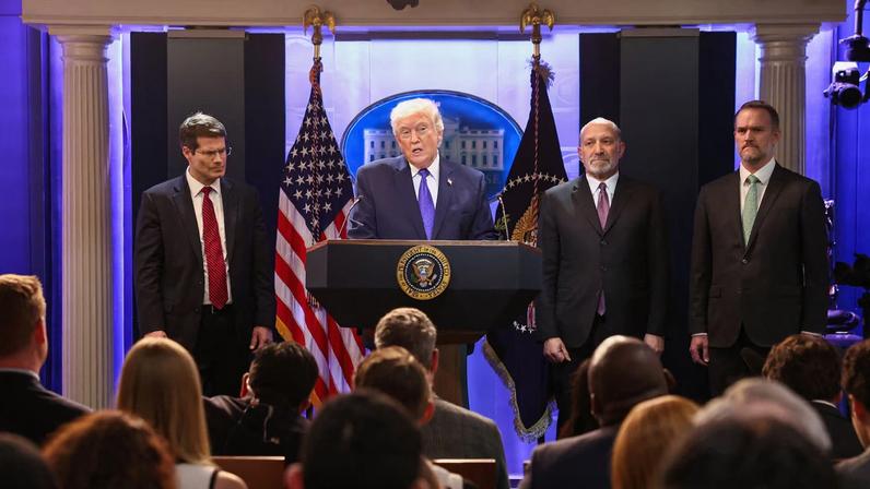 U.S. President Donald Trump, flanked by Secretary of Commerce Howard Lutnick, Trade Representative Jamieson Greer and Solicitor General D. John Sauer, speaks during a press briefing at the White House, following the Supreme Court's ruling that Trump had exceeded his authority when he imposed tariffs, in Washington, D.C., U.S., January 20, 2026. REUTERS/Kevin Lamarque
