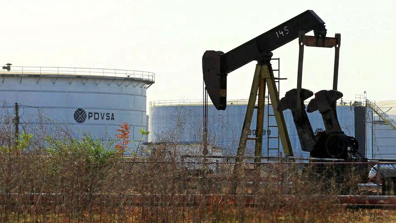 An oil pumpjack and a tank with the corporate logo of state oil company PDVSA are seen in an oil facility in Lagunillas, Venezuela January 29, 2019. REUTERS/Isaac Urrutia