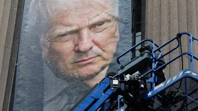 New banners depicting U.S. President Donald Trump are hung on the Department of Justice building in Washington