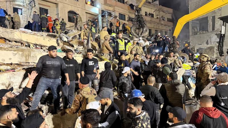 Rescue teams search for survivors after a building collapsed in Tripoli