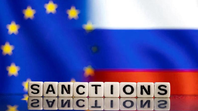 Plastic letters arranged to read "Sanctions" are placed in front of EU and Russia's flag colors in this illustration taken February 25, 2022.