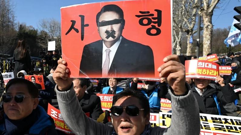 A protester holds a sign of former South Korean President Yoon Suk-yeol in Seoul on Feb. 19.