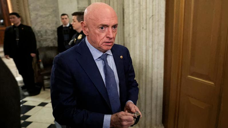 U.S. Senator Mark Kelly (D-AZ) winds his watch as he departs the Senate floor after an evening vote at the U.S. Capitol in Washington, D.C., U.S., January 12, 2026. REUTERS/Jonathan Ernst/File Photo