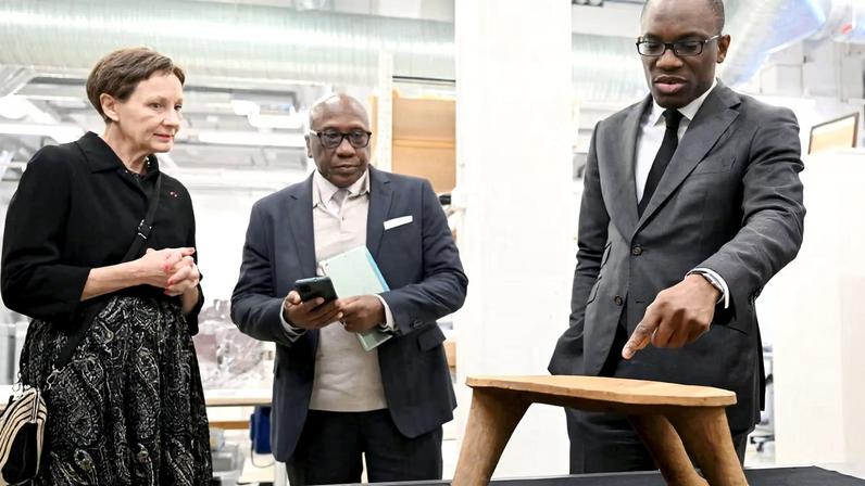 From left: Elina Anttila, the director general of the the Finland National Museum; Olushegun Adjadi Bakari, Benin's minister of foreign affairs, and Alain Godonou, the director of the Benin’s Museums programmes, view a kataklè. The object was returned to Benin in 2024