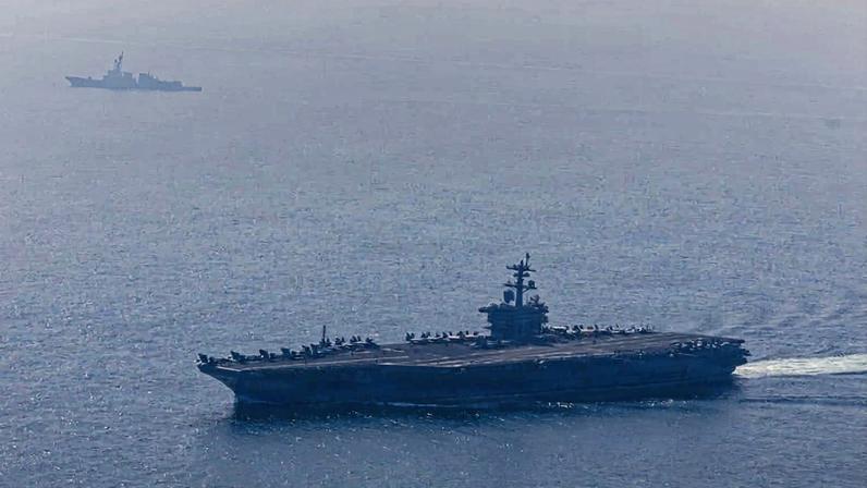 Nimitz-class aircraft carrier USS Abraham Lincoln and Arleigh Burke-class guided-missile destroyer USS Frank E. Petersen Jr. sail in the Arabian Sea on Feb. 6. Jesse Monford/U.S. Navy via Getty Images