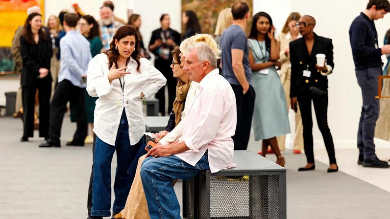 Football legend Joe Montana touches down on a bench outside the Frieze Impact Prize stand