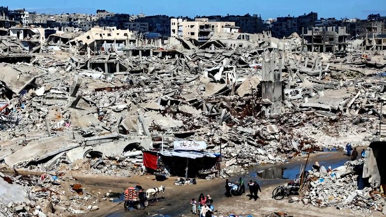 Palestinians make their way through the ruble of destroyed buildings in the Sheikh Radwan neighborhood of Gaza City on February 4.