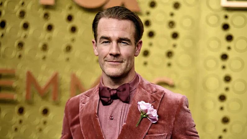 James Van Der Beek in a pink velvet suit with a bow tie and a pink flower on the lapel.