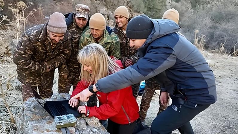 Michaela Strachan and the Gissar rangers celebrate spotting the elusive snow leopard on camera trap footage