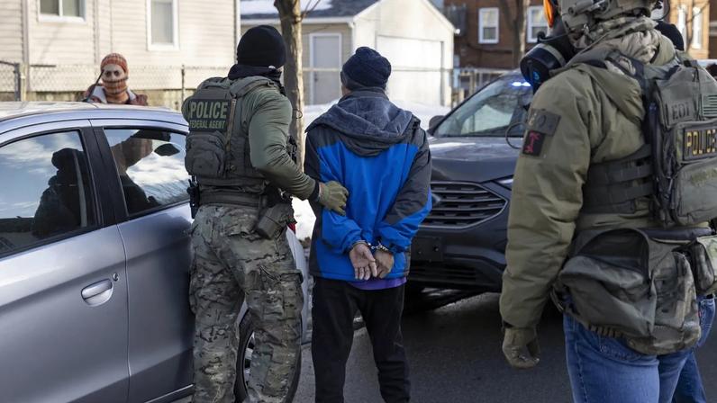 Federal agents arrest a man after they stopped and questioned him in the street during an Immigration Enforcement Operation in Minneapolis, Minneapolis, MN, U.S.