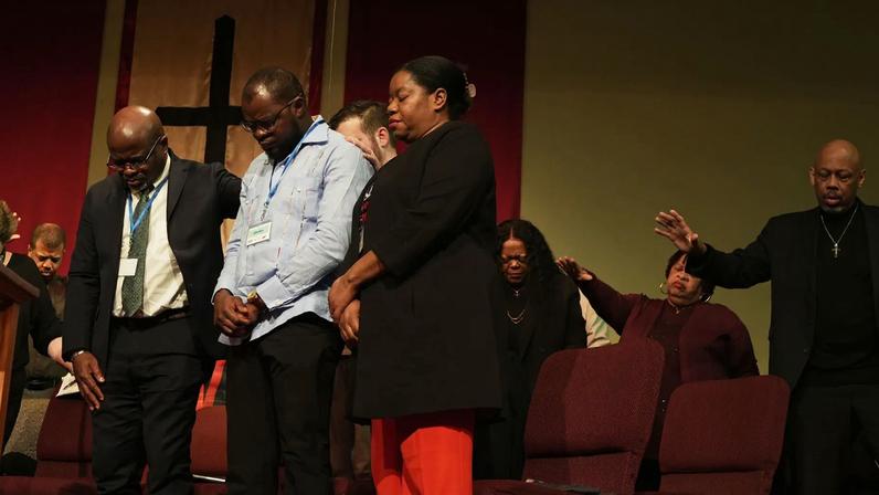 Faith leaders pray at St. John Missionary Baptist Church in Springfield, Ohio.