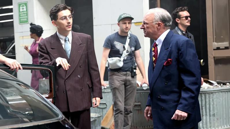 Timothée Chalamet appears to be giving an homage to the style of his “Marty Supreme” character on the red carpet, sporting suits in a similar double-breasted style.