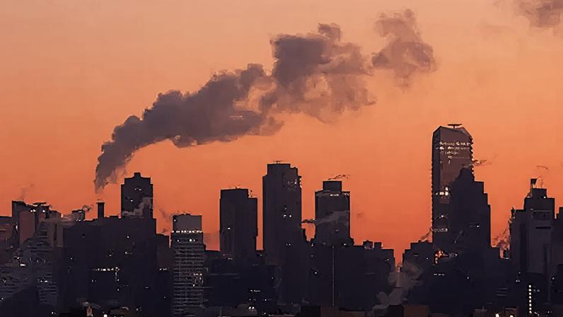Getty Images An emission comes out of a smoke stack as the sun rises in New York City