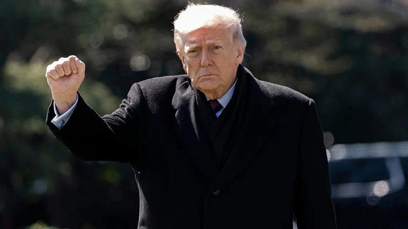 President Donald Trump pumps his fist as he walks to depart on Marine One from the South Lawn of the White House, Wednesday, March 18, 2026, in Washington.