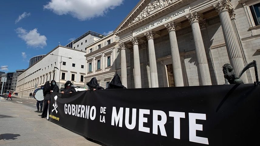FILE - Demonstrators against euthanasia rally outside the Spanish Parliament in Madrid, Spain, Thursday, March 18, 2021.
