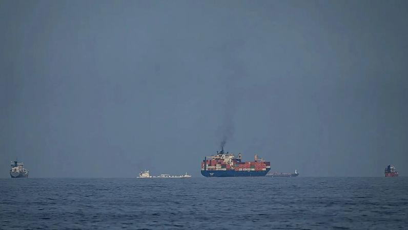 Oil tankers and cargo ships line up in the Strait of Hormuz as seen from Khor Fakkan, 11 March, 2026