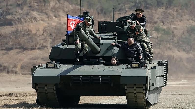 Kim Jong Un, his daughter and soldiers on a tank at a military training base in North Korea, 19 March, 2026