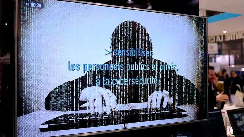 A television screen reads "Alerting public organizations and people to cybersecurity" at the International Cybersecurity forum in Lille, northern France,on Jan. 23, 2018.