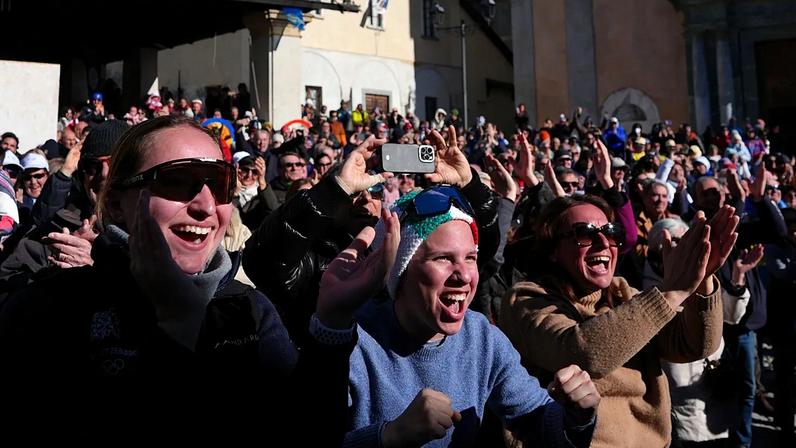 Fans react as they watch Federica Brignone wins a gold medal in an alpine ski at the 2026 Winter Olympics.