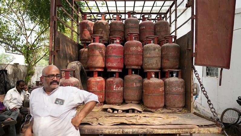 An employee at a depot waits to distribute household cylinders of liquified natural gas to consumers, in Lucknow, India, Wednesday, March 11, 2026.